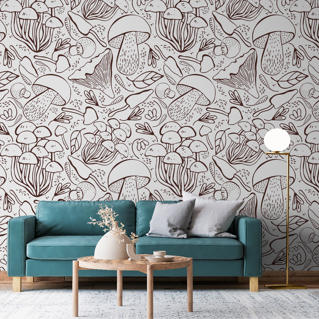 Living Room - A cozy living room featuring a teal sofa with gray pillows, a small wooden coffee table crafted with local craftsmanship, and a floor lamp. The walls are adorned with Decor2Go Wallpaper Mural featuring whimsical mushroom and Exotic Plants Sketch.