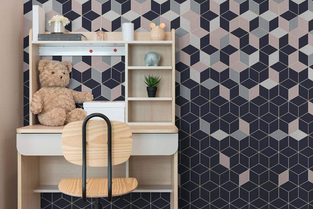 A cozy children's study area featuring a wooden desk with shelves containing a teddy bear, books, and small decorative items, against a stylish Decor2Go Falling Cubes Wallpaper Mural.