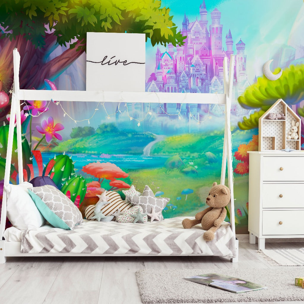 A colorful children's bedroom featuring a bed with a whimsical forest-themed backdrop, a teddy bear on striped bedding, a Decor2Go Fantasy Kingdom Wallpaper Mural, and a white dresser.