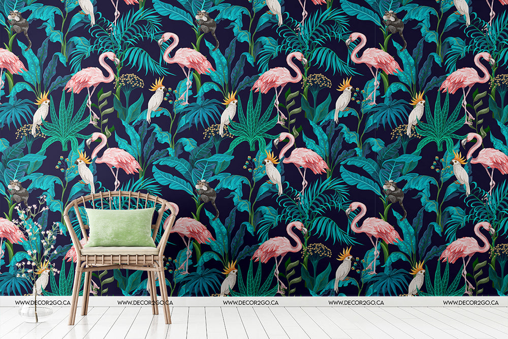 A vibrant Flamingo Fever Wallpaper Mural by Decor2Go featuring pink flamingos, large lush green leaves, and exotic flowers, with a modern wooden chair with a green cushion against it, perfect for creating a feature wall.