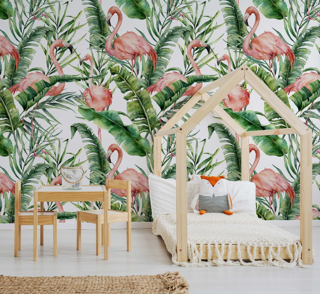Kids Room - A stylish children's room featuring a house-shaped bed frame with a white mattress, small wooden table and chairs, Decor2Go Wallpaper Mural Flamingos and Tropical Leaves wallpaper mural with lush green foliage, and a woven rug on the floor.