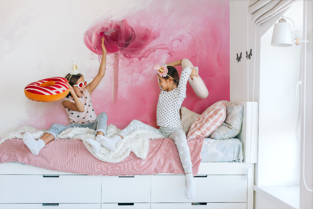 Bedroom - Floral Blush Wallpaper Mural girls are playing  with pillows in the bedroom