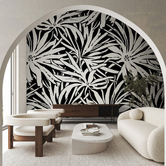Modern living room with cream furniture, a white oval coffee table, and York Wallcoverings’ Floral Canopy Black Wallpaper Mural as a striking feature wall, viewed through a large archway.
