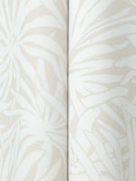 The Floral Canopy Cream Wallpaper by York Wallcoverings features a close-up of embossed floral and leaf patterns in light beige and cream, showcasing overlapping shapes and soft, textured details.