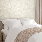 Bedroom - A cozy showcases a neatly made bed with white linens and a beige knit blanket. Behind the bed, York Wallcoverings' Floral Canopy Linen Wallpaper (60 SqFt) adds a botanical touch, complemented by beige curtains to the side