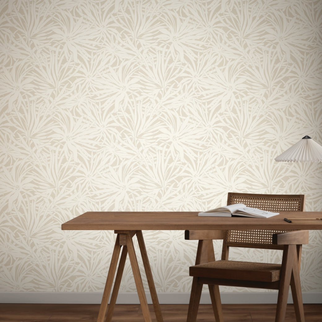 Home Office - A wooden desk and chair stand on hardwood floors, set against York Wallcoverings' Floral Canopy Linen Wallpaper. An open book and a white lamp on the desk complete this calm, minimal with a soft botanical touch