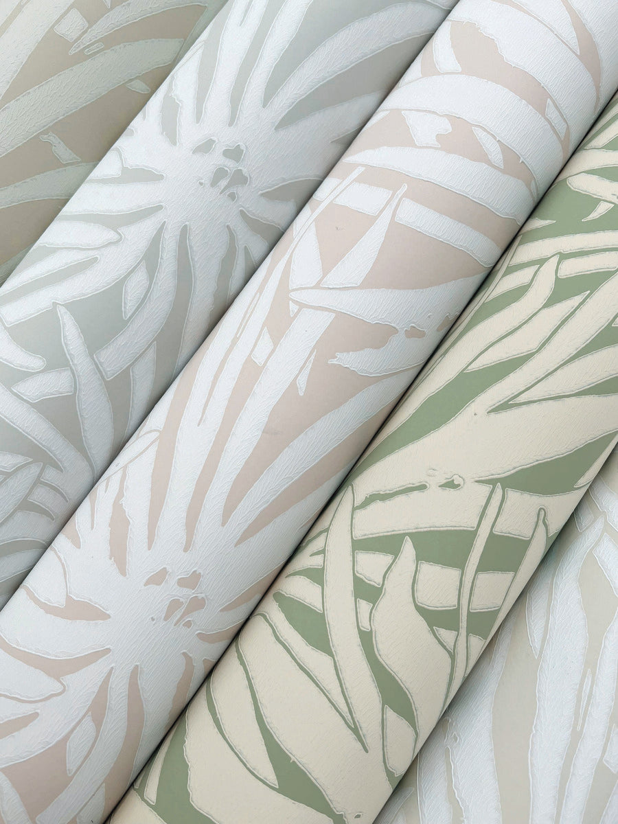 Three rolls of York Wallcoverings’ Floral Canopy Blush Wallpaper (60 SqFt), featuring abstract leaf patterns in soft sage green, beige, and off-white tones arranged diagonally.