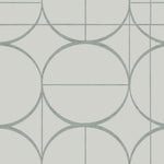 The Fog & Silver Sun Circles Wallpaper by York Wallcoverings features a minimalist geometric design with large overlapping circles and intersecting lines on a light background, reminiscent of Art Deco wallpaper, with soft, muted colors that elegantly complement its subtle metallic finishes.