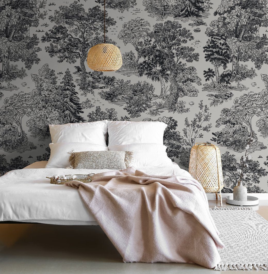 Bedroom - A cozy bedroom features a white bed adorned with light gray and pink blankets, complemented by beige cushions. A woven side lamp and a wicker pendant light enhance the space, while the Forest Reverie Wallpaper Mural by Decor2Go adds an intricate black and white pattern that brings a natural touch to the room.