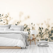 Bedroom - A serene bedroom featuring a neatly made bed with gray and white bedding, a wooden bedside table with a lamp and clock, set against a soft beige wall adorned with Decor2Go Wallpaper Mural's Fragile Flowers Wallpaper Mural.