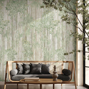 Living Room - A modern with a light wood sofa, gray and black cushions, a low wooden table, and the Aspen Grove Forest Wallpaper Mural by York Wallcoverings in green tones as a botanical accent, next to a large potted plant