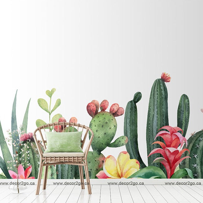 A cozy corner with a green chair against a wall adorned with the Garden of Cactus Wallpaper Mural by Decor2Go Wallpaper Mural, featuring various types of cacti and succulent plants in a watercolor style.