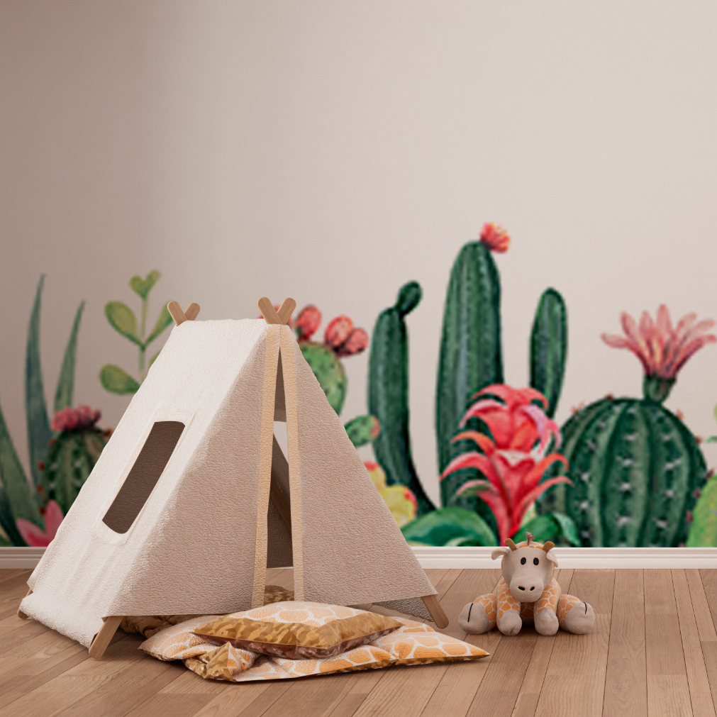 A cozy children's play tent designed like a teepee in a room with Decor2Go Garden of Cactus Wallpaper Mural. A plush giraffe toy is placed next to the tent on a wooden floor.