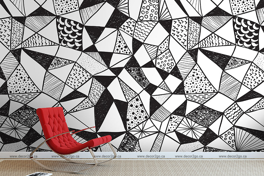 A modern room with a vibrant red lounge chair in front of a wall covered in Decor2Go Wallpaper Mural filled with various textures and shapes.
