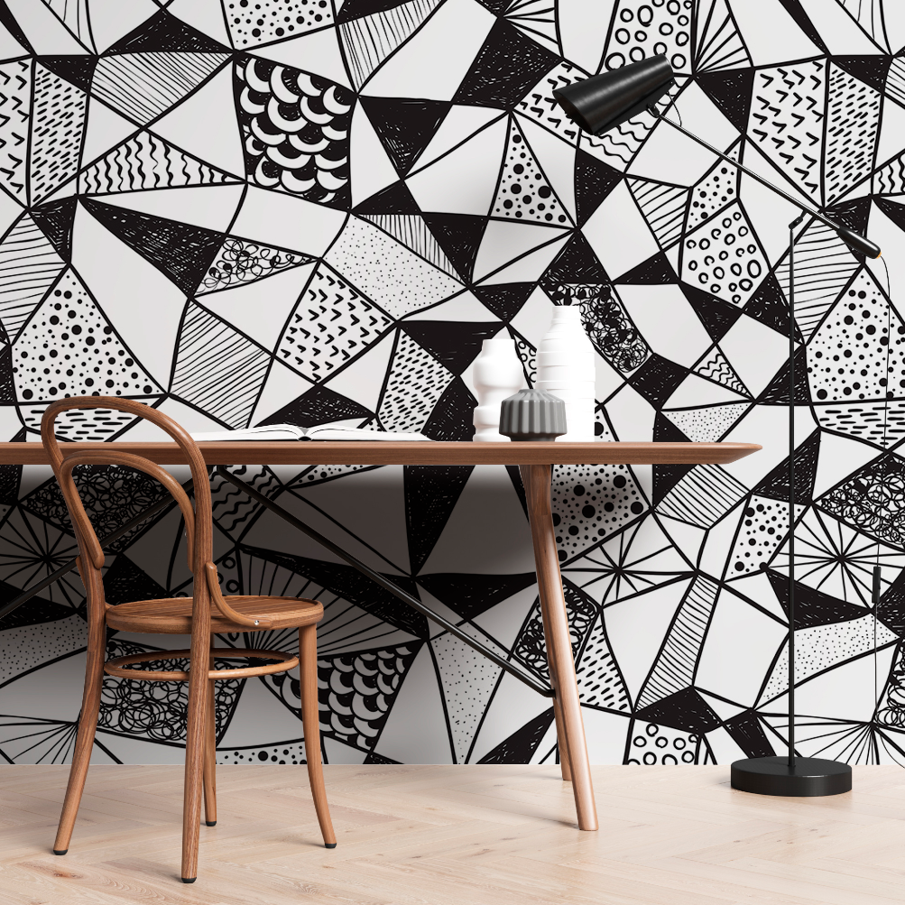 A modern workspace featuring a wooden chair and desk against a bold, Decor2Go Wallpaper Mural. Decor includes a small white vase and grey lamp.