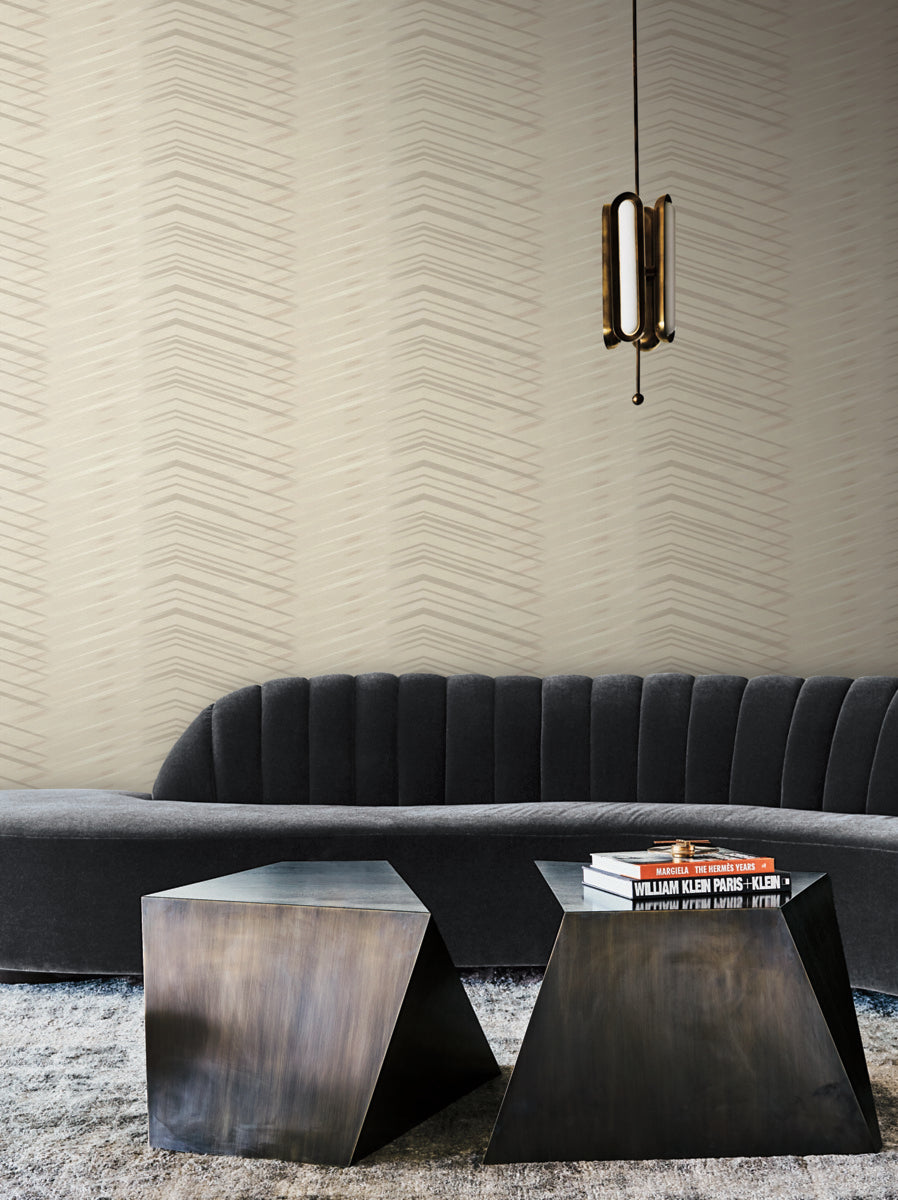 Living Room - Modern featuring a textured York Wallcoverings Glistening Chevron Wallpaper Blonde (56 sq.ft.), a dark gray sofa, two unique geometric coffee tables, and a stylish hanging pendant light