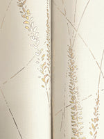 Close-up of Graceful Willow Cotton Wallpaper by York Wallcoverings (60 SqFt), a textured light beige metallic gold wallpaper with an abstract pattern of gold and tan botanicals and thin intersecting lines for a subtle, elegant look.