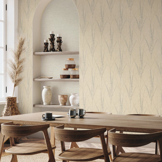 A modern dining room features a light wood table, six matching chairs, built-in shelves with vases and candles, and York Wallcoverings’ Graceful Willow Putty Wallpaper (60 SqFt), adding subtle elegance. A large window fills the space with natural light.