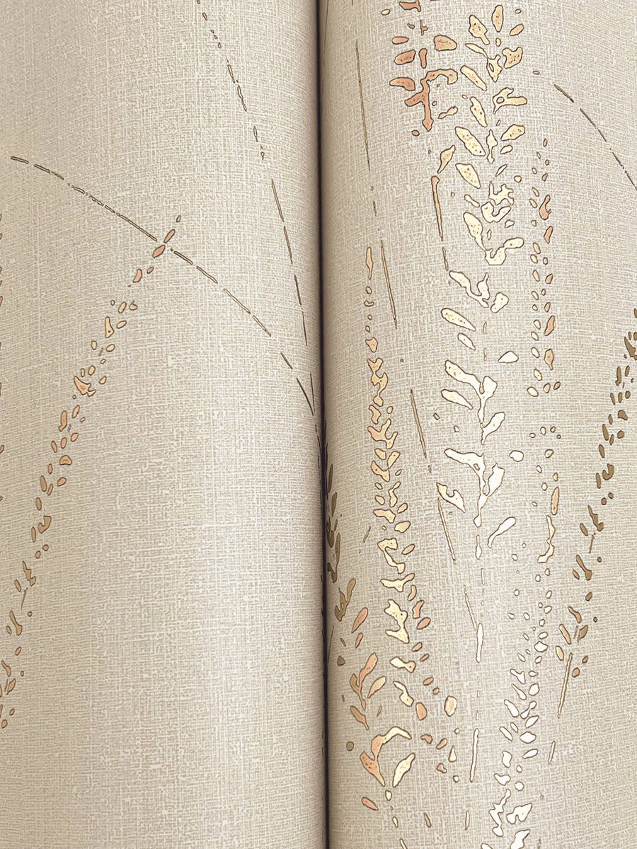 Close-up of an open book with textured, beige pages accented by gold-embossed designs resembling Graceful Willow Stone Wallpaper (York Wallcoverings, 60 SqFt). The book's spine is centered in the image.