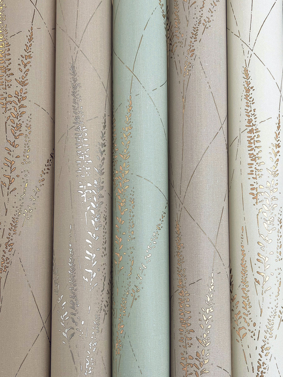 Four rolls of York Wallcoverings Graceful Willow Lagoon Wallpaper (60 SqFt) in soft beige, taupe, and pale green with delicate metallic gold and silver botanical patterns and fine lines.