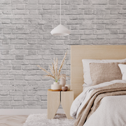 Bedroom - A cozy bedroom corner featuring a neatly made bed with a beige headboard and knit throw, a wooden side table with a vase of dried plants, under a pendant light against the Decor2Go Wallpaper Mural background.