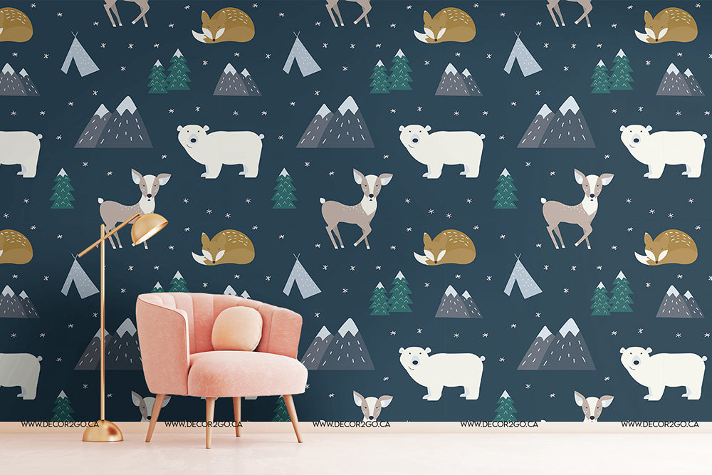 A room with a statement wall featuring a Decor2Go Wallpaper Mural hand-drawn animal forest wallpaper with illustrations of polar bears, deer, rabbits, and trees in soft colors. There's a pink armchair and a floor lamp.