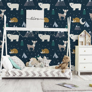 Bedroom - A child's bedroom with a Decor2Go Wallpaper Mural featuring a hand-drawn animal forest wallpaper, along with a small bed with a teddy bear, a white dresser, and a house-shaped shelf.