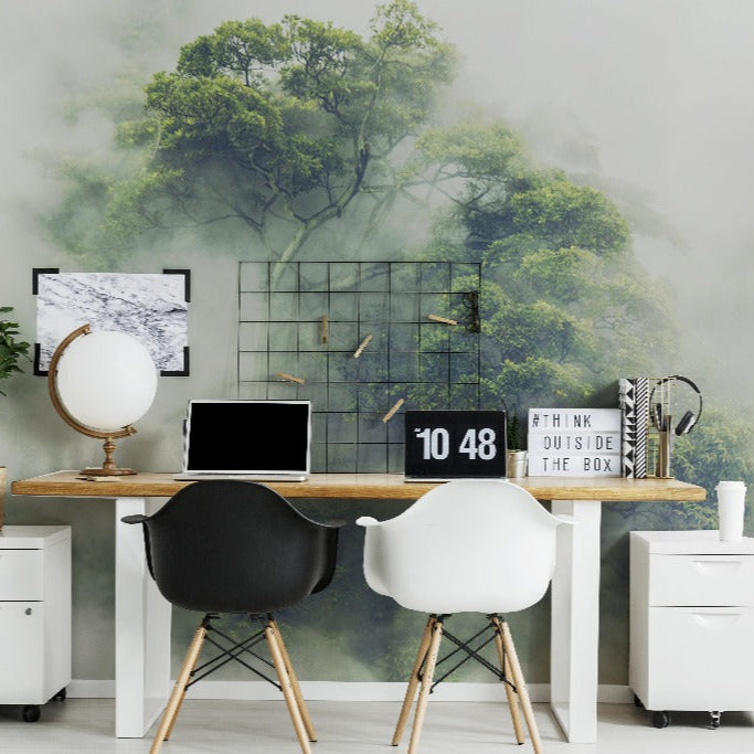 Home Office - A modern home office with a wooden desk, two white chairs, a laptop, decorative items, and a large Decor2Go Wallpaper Mural of a green, misty forest.