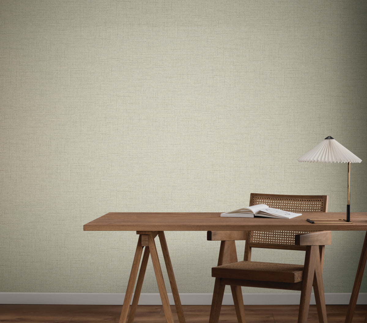 Home Office - A minimalist with a wooden desk and chair, an open book, and a small table lamp with a pleated shade, set against York Wallcoverings’ Hillswick Tweed Fog Wallpaper (60 SqFt), in light beige for subtle texture