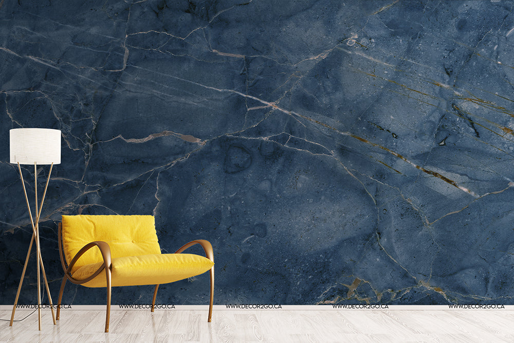 A modern interior featuring a bright yellow armchair and a tall white floor lamp beside a Decor2Go Wallpaper Mural feature wall with intricate white and gold veins.