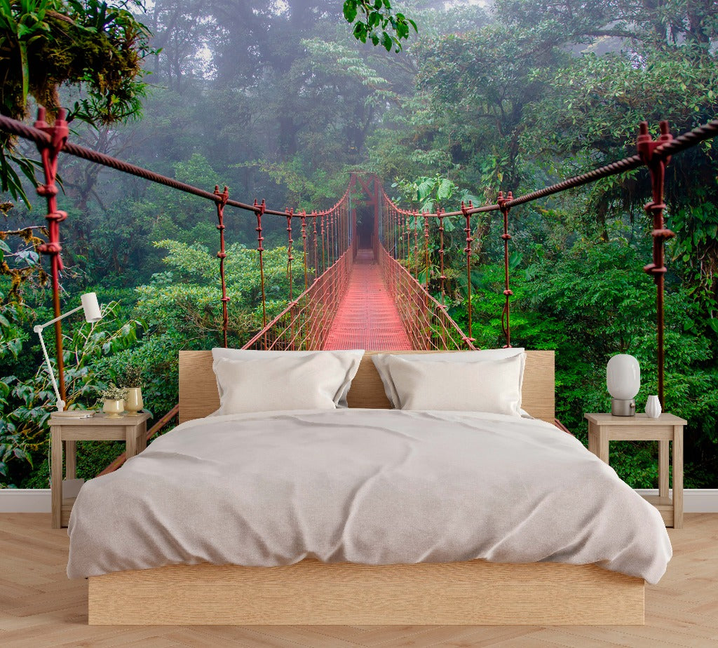 Living Room - A modern living room with a large sofa and white decor, featuring a Decor2Go Wallpaper Mural of the "Into the Forest" wallpaper mural of a lush, foggy forest.