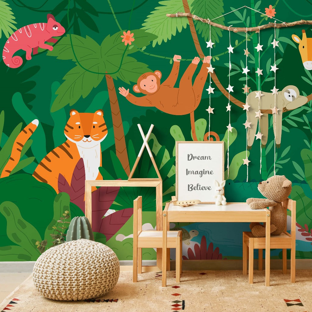 A vibrant children's room with a Decor2Go Wallpaper Mural, featuring wall murals of a sloth, tiger, and foliage. A desk with a chair, hanging decor, and stuffed toys complement.