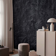 Living Room - A modern living room corner with a Decor2Go Wallpaper Mural feature wall, light curtains, a side cabinet with a lamp and decor, and a gray upholstered stool.