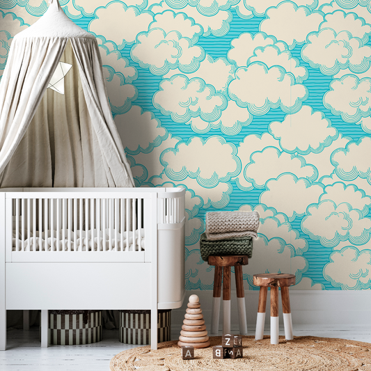 A stylish nursery featuring a white crib, a tepee canopy, a Decor2Go Living in the Clouds Wallpaper Mural, a knit blanket on a chair, and wooden stools on a circular rug.