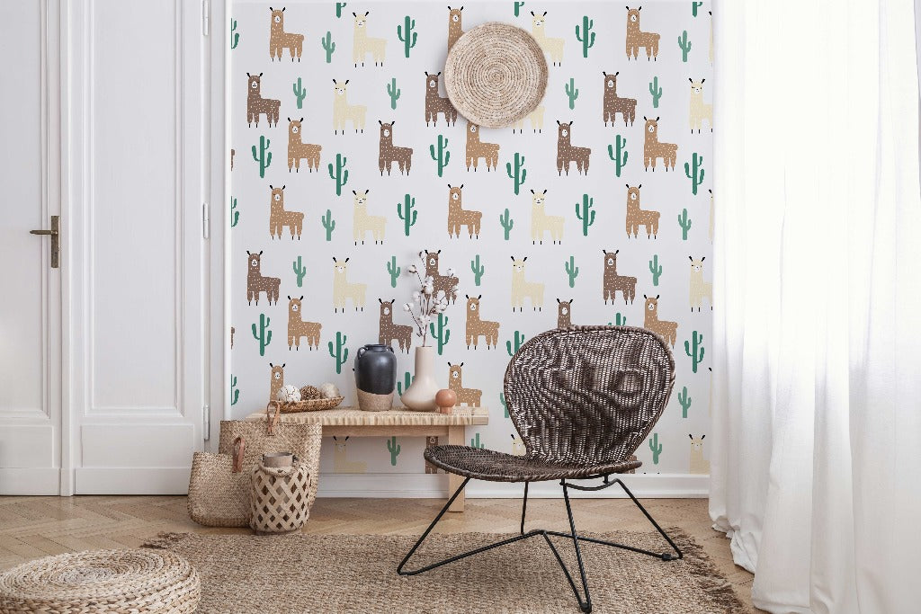 Kids Room - A cozy children's room corner with a rattan chair, complemented by a straw hat on the wall and a side bench displaying ceramics and a plant, against Decor2Go Wallpaper Mural with Llama and Cactus Pattern.