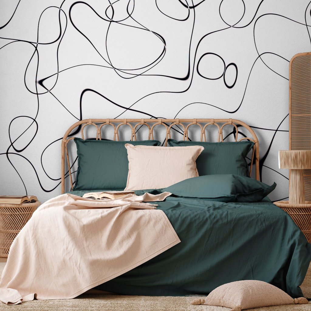 A stylish modern bedroom featuring a Decor2Go Wallpaper Mural on a white wall, with a rattan headboard, dark green bedding, a beige throw, and matching pillows.