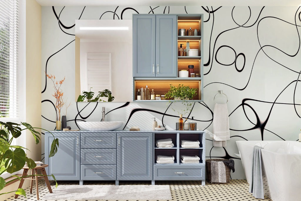 A stylish bathroom with blue cabinetry, open shelves displaying neatly organized towels and toiletries, set against a wall with Decor2Go Lovely Swirls Wallpaper Mural. A plant adds a touch of greenery.