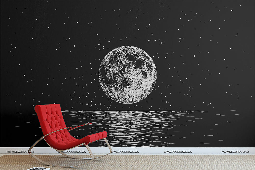 A modern room with a dark wall featuring a large Lunar Etch Wallpaper Mural by Decor2Go Wallpaper Mural above an ocean, and a stylish red lounge chair in front of it.