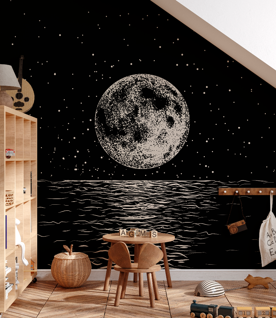 A child's bedroom featuring a large, Decor2Go Wallpaper Mural Lunar Etch moon mural on the wall above a black wavy sea design. The room includes a wooden table with chairs, toys, and a bookshelf.