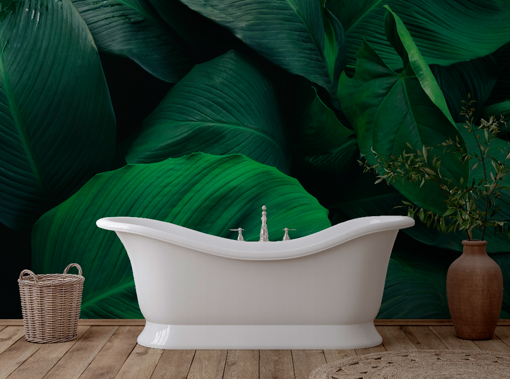 Bathroom - A white freestanding bathtub in a tropical-themed bathroom with Decor2Go Wallpaper Mural, a wooden floor, and a brown vase next to a wicker basket.
