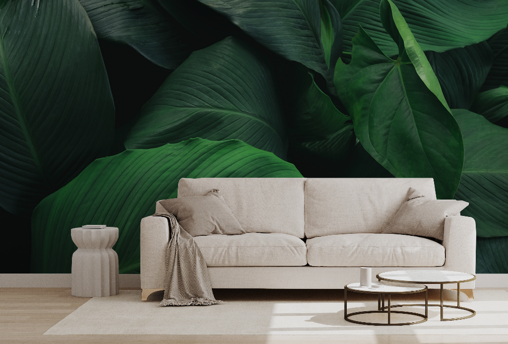 Living Room - A cozy living room featuring a beige sofa with a blanket thrown over one arm, located in front of a striking deep green Decor2Go Wallpaper Mural. Beside the sofa are a small white vase and.