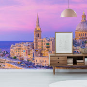 Living Room - Modern living room with stylish furniture overlooking a scenic city with historic architectural buildings under a vibrant sunset sky, enhanced by a Decor2Go Wallpaper Mural.