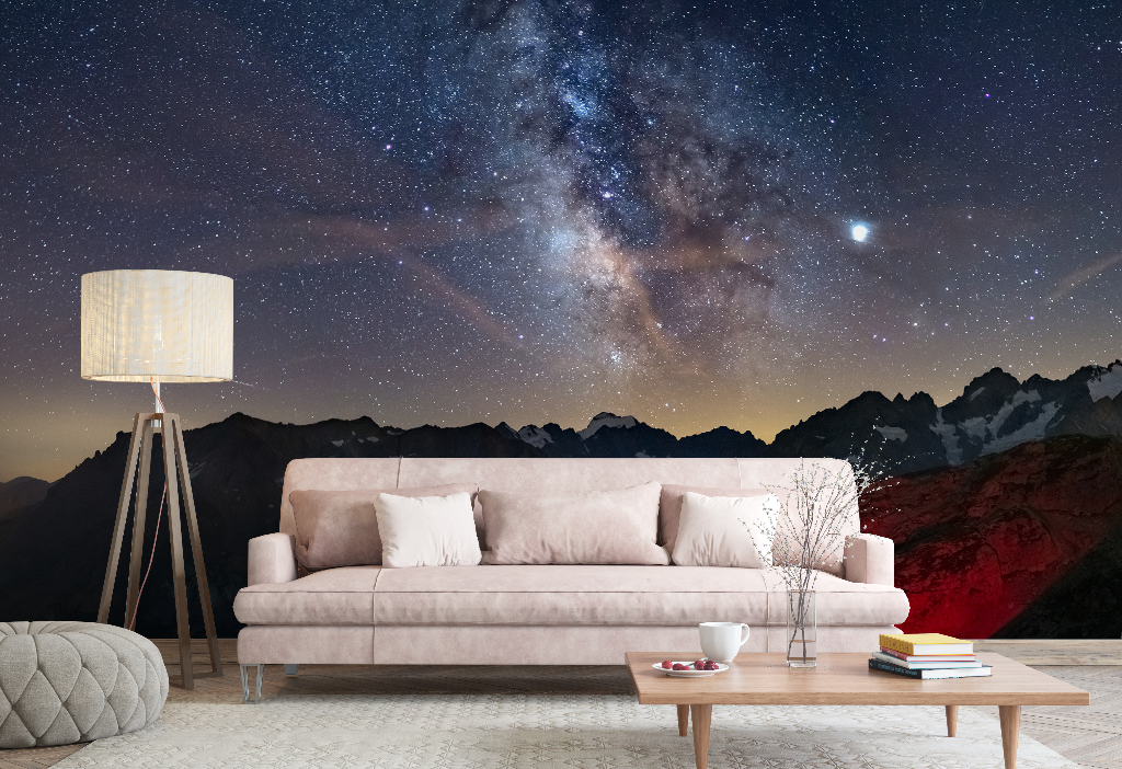 Living Room - A stylish living room with a beige sofa, wooden coffee table, and floor lamp, set against a large Decor2Go Wallpaper Mural of the Milky Way and mountainous landscape.