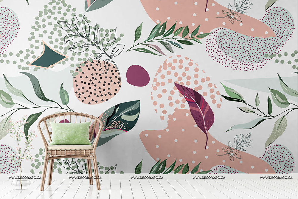 A modern room with a white wall featuring a colorful Millenial Collage Wallpaper Mural from Decor2Go Wallpaper Mural. A wooden chair with green cushions is positioned in front of the mural.