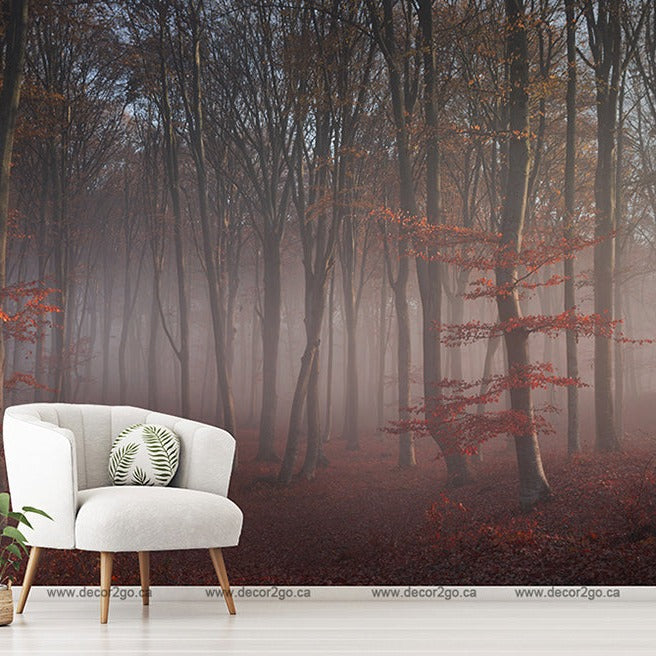 A stylish white armchair with a green pillow, a standing lamp, and a potted plant, positioned in a room with a wall-sized Decor2Go Wallpaper Mural featuring misty red forest.