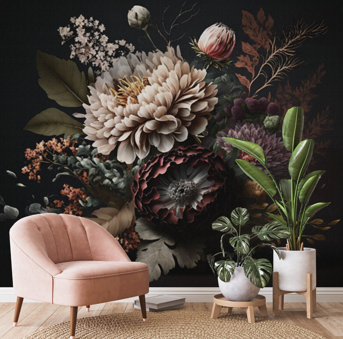 A stylish room features a pink velvet chair and two potted plants against a dark wall adorned with the Moody Floral Elegance Wallpaper Mural by Decor2Go. This artwork, showcasing a dramatic array of flowers and leaves, exudes moody floral elegance, creating a sophisticated ambiance.