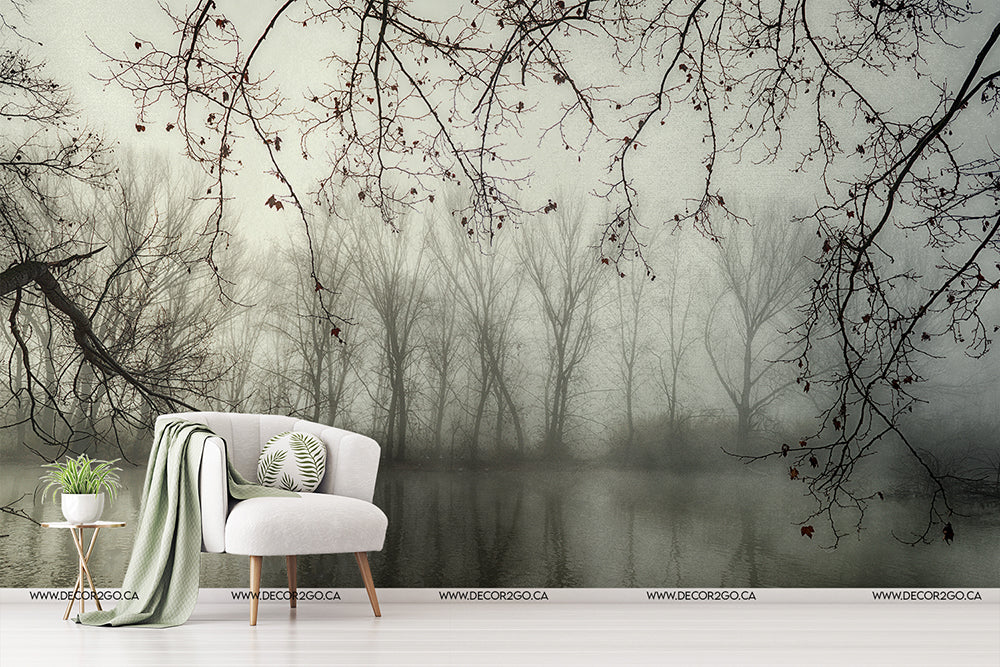 Living Room - A stylish living room setup with a white armchair and a green throw blanket beside a small table with a plant, against a wall featuring a Decor2Go Wallpaper Mural of the Murky Forest scene.