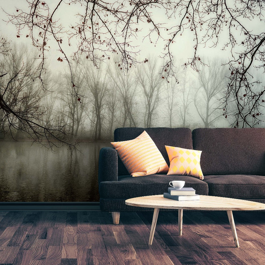 Living Room - A serene living room featuring a dark gray couch with vibrant pillows, a small white coffee table with a cup, set against a Decor2Go Wallpaper Mural of Murky Forest Wallpaper Mural.