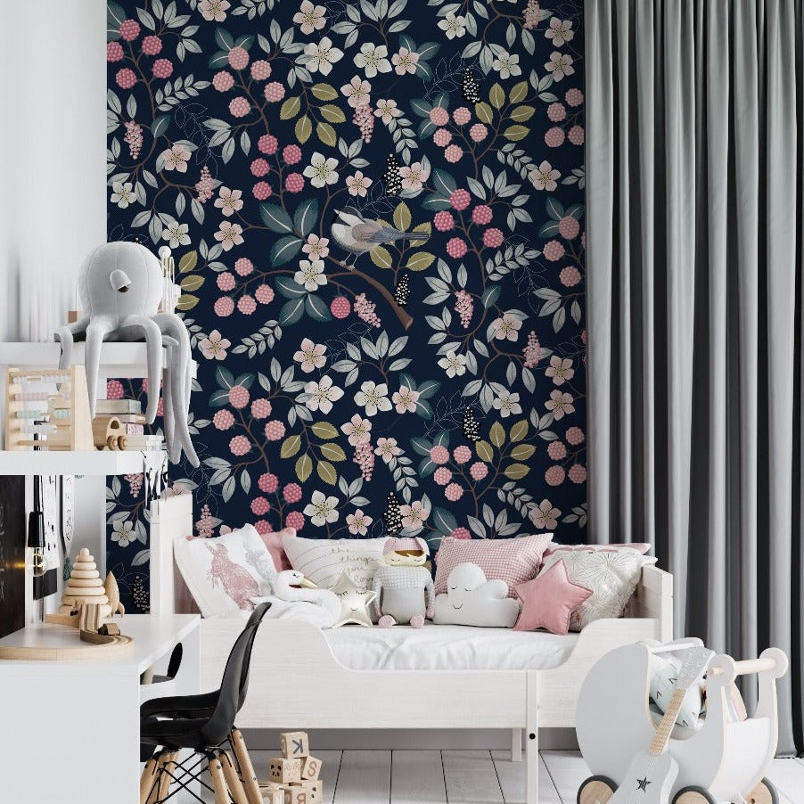 A stylish children's room featuring a white bed adorned with plush toys, a wooden chair, a rocking horse, and a toy shelf against a dark floral feature wall, complemented by light grey curtains from Decor2Go Wallpaper Mural.