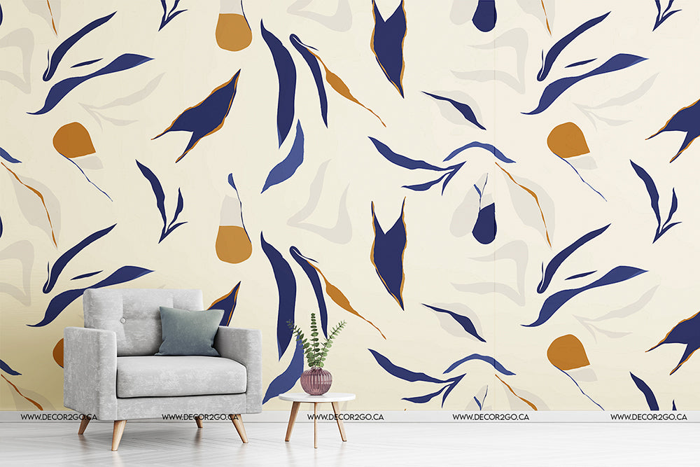 A stylish interior design featuring a cozy gray armchair with a cushion, a small round table with a potted plant, against a large wall covered in Decor2Go Wallpaper Mural in blue, gold.